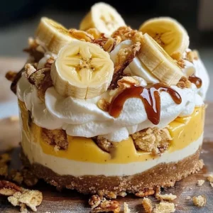 Delicious Banana Split Cheesecake topped with bananas, whipped cream, and chocolate sauce