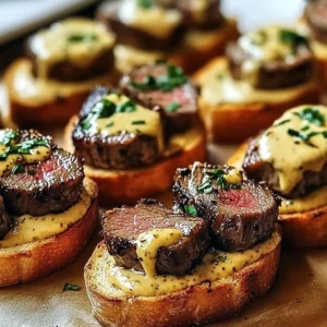 Beef tenderloin crostini topped with herbs on crispy bread