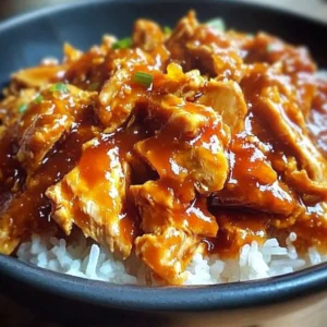 Crockpot Orange Chicken served with steamed rice and garnished with green onions