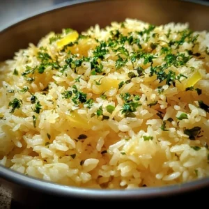 Delicious Greek Lemon Rice served with fresh herbs and lemon slices