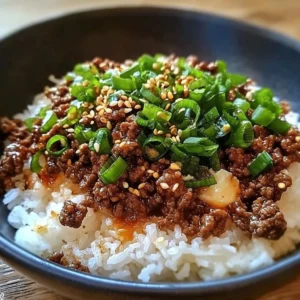 Korean Ground Beef Bowl topped with fresh vegetables and flavorful sauces