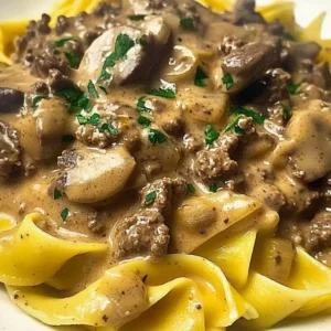 Creamy Ground Beef Stroganoff served over egg noodles with parsley garnish