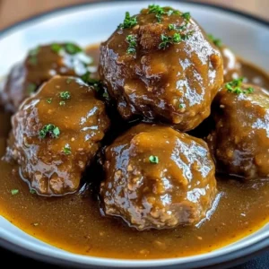 Juicy beef meatballs served with rich gravy on a plate