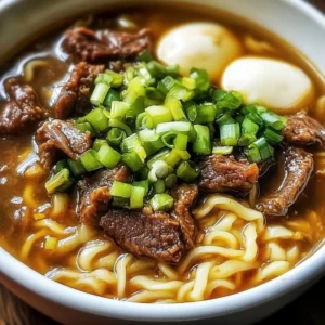 Bowl of New Orleans Yakamein, a savory noodle soup with rich flavors and spices.