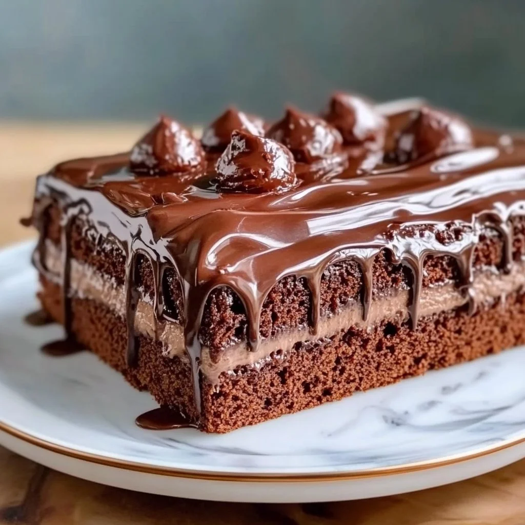 Delicious Chocolate Three Milks Cake topped with whipped cream and chocolate shavings.