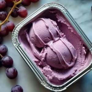Delicious grape ice cream in a cone, showcasing its vibrant color and creamy texture.