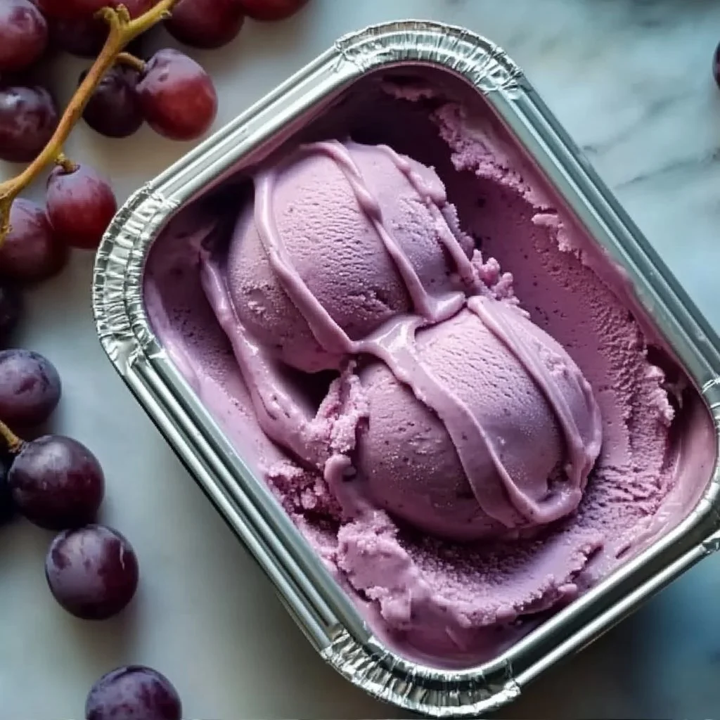 Delicious grape ice cream in a cone, showcasing its vibrant color and creamy texture.
