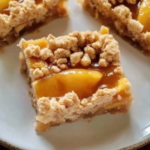 Honey-glazed peach crumble bars with a golden crust and fresh peaches