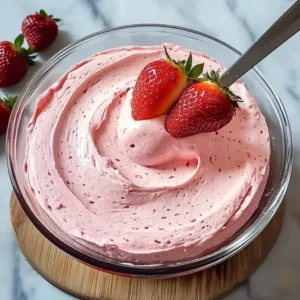 Strawberry mousse cake filling in a dessert bowl with fresh strawberries